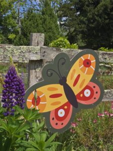 a cut out of a butterfly is shown attached to a fence