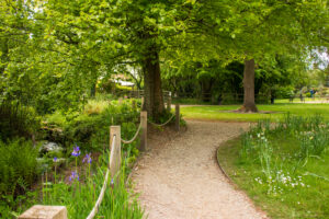 a garden path next to a stream
