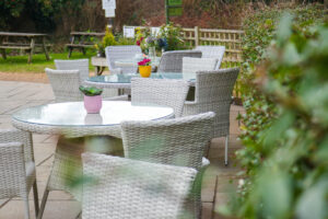 tables and chairs are shown on a patio outside
